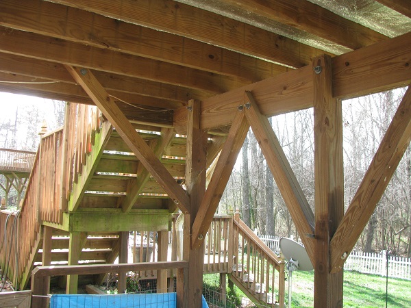 Structural framing connection defect under residential wood deck structure